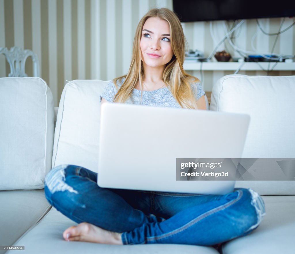 Beautiful young woman working with laptop
