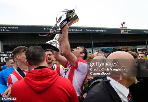 Lincoln City's Matt Rhead celebrates with the Vanarama National League trophy after the Vanarama National League match between Lincoln City and...