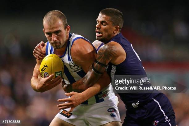 Ben Cunnington of the Kangaroos is tackled by Bradley Hill of the Dockers during the round five AFL match between the Fremantle Dockers and the North...