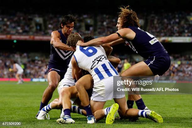 Griffin Logue of the Dockers tries to pull Lachlan Hansen of the Kangaroos off Michael Walters of the Dockers during the round five AFL match between...