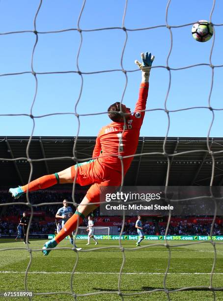 Jack Butland of Stoke City attempts to save as Tom Carroll of Swansea City scores his sides second goal during the Premier League match between...