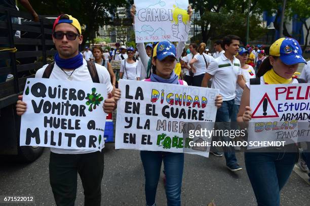 Venezuelan opposition activists march towards the Catholic Church's episcopal seats nationwide, in Caracas, on April 22, 2017. Venezuelans gathered...