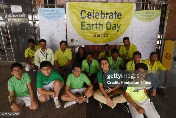 School children and Safai Sena members educating the public on the International Earth Day at the New Delhi Railway Station, on April 22, 2017 in New...