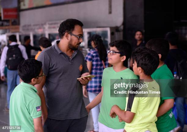 School children and Safai Sena members educating the public on the International Earth Day at the New Delhi Railway Station, on April 22, 2017 in New...