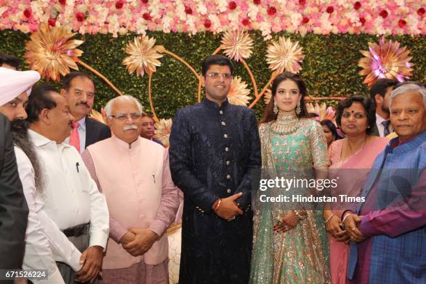 Haryana Chief Minister Manohar Lal Khattar, Union Minister Harsh Vardhan with INLD MP Dushyant Chautala and Meghna Ahlawat during their wedding...