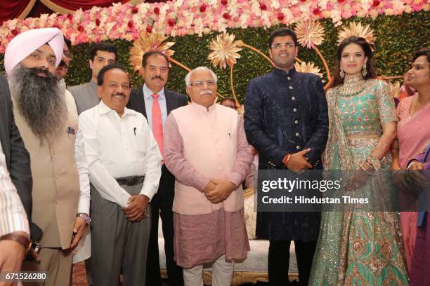 Haryana Chief Minister Manohar Lal Khattar, Union Minister Harsh Vardhan with INLD MP Dushyant Chautala and Meghna Ahlawat during their wedding...