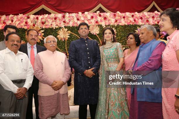 Haryana Chief Minister Manohar Lal Khattar, Union Minister Harsh Vardhan with INLD MP Dushyant Chautala and Meghna Ahlawat during their wedding...