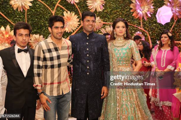 Boxer Vijender Singh with INLD MP Dushyant Chautala and Meghna Ahlawat during their wedding reception at Ashoka Hotel, on April 20, 2017 in New...