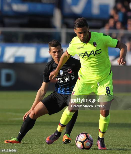 Saphir Sliti Taider of Bologna FC is challenged by Remo Freuler of Atalanta BC during the Serie A match between Atalanta BC and Bologna FC at Stadio...