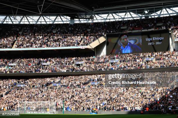 An image of Ugo Ehiogu is displayed on the big screen as fans applaud during The Emirates FA Cup Semi-Final between Chelsea and Tottenham Hotspur at...