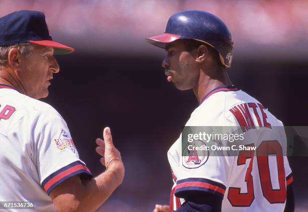 Third base coach Bobby Knoop and Devon White of the California Angels circa 1985 discuss stratagey at the Big A in Anahiem, California.