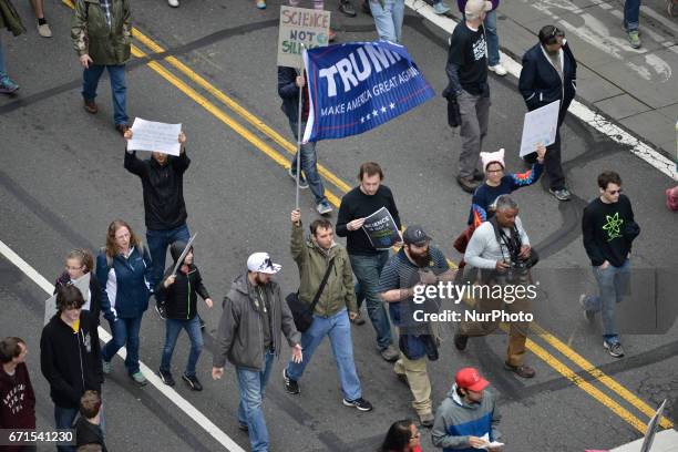 One person is seen carrying a Trump flag, during the National March for Science, in Philadelphia, PA, on Earth Day, April 22, 2017.