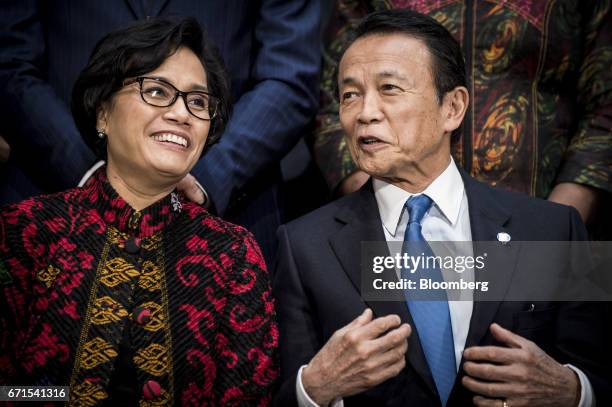 Sri Mulyani Indrawati, Indonesia's finance minister, left, and Taro Aso, Japan's finance minister, speak before a group photograph at the spring...