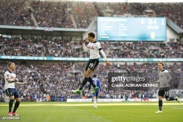 Tottenham Hotspur's English midfielder Dele Alli celebrates scoring the team's second goal with Tottenham Hotspur's Belgian defender Toby...