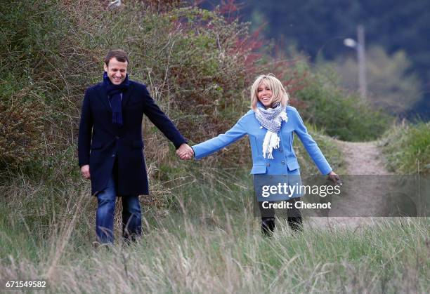 Head of the political movement En Marche! and candidate for the 2017 presidential election, Emmanuel Macron and his wife Brigitte Trogneux pose for a...