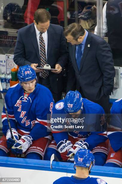 Head coach Alain Vigneault and associate coach Scott Arniel of the New York Rangers review a play on iPads placed on the benches during the game...