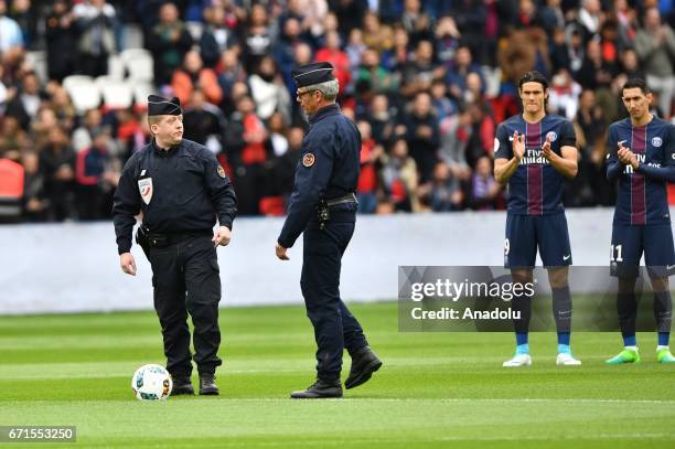 French police officers are invited to kick off the French Ligue 1 soccer match between Paris Saint-Germain and Montpellier HSC at the Parc des...
