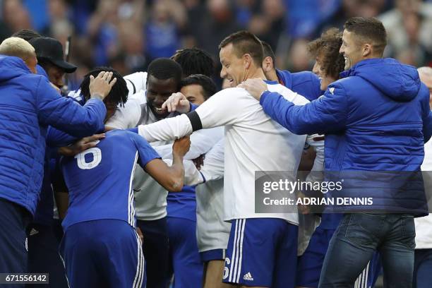 Chelsea's English defender John Terry celebrates victory with teammates after the FA Cup semi-final football match between Tottenham Hotspur and...