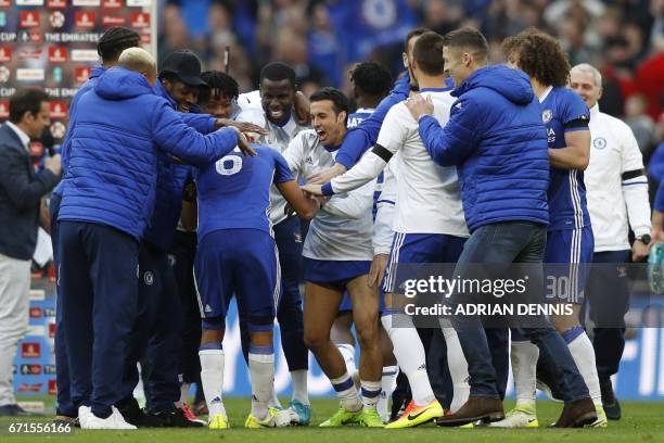 Chelsea's Spanish midfielder Pedro celebrates victory with teammates after the FA Cup semi-final football match between Tottenham Hotspur and Chelsea...