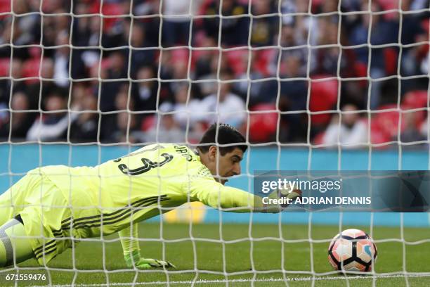 Chelsea's Belgian goalkeeper Thibaut Courtois saves a goal off Tottenham Hotspur's English striker Harry Kane's free kick during the FA Cup...