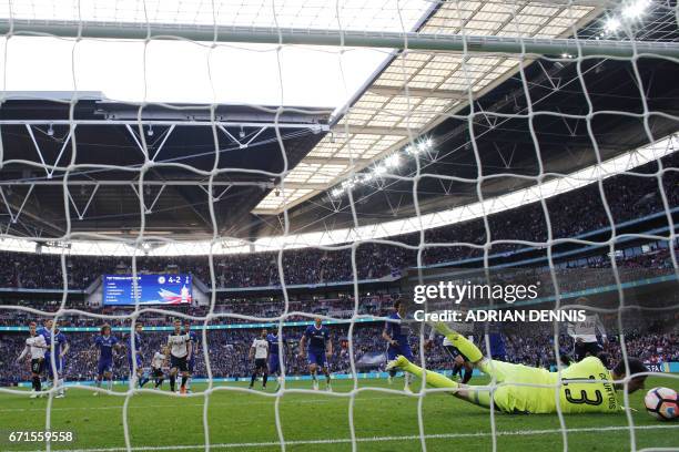 Chelsea's Belgian goalkeeper Thibaut Courtois saves a goal off Tottenham Hotspur's English striker Harry Kane's free kick during the FA Cup...