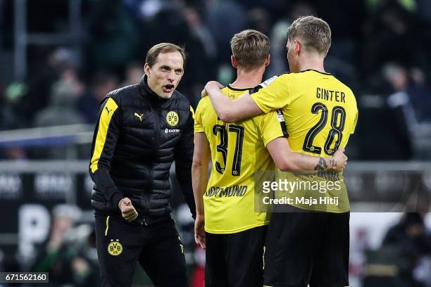 Head coach Thomas Tuchel of Dortmund , Erik Durm and Matthias Ginter celebrate after the Bundesliga match between Borussia Moenchengladbach and...