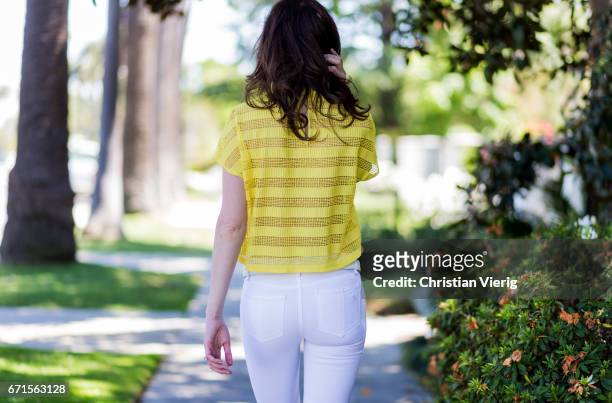 Model Julia Lescova wearing white jeans Rag&Bone, French Mauve yellow striped top, Chloe shoes, Celine sunglasses, Chanel bag on April 21, 2017 in...