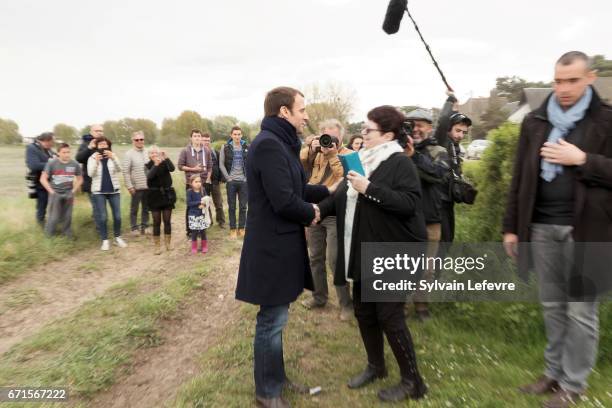 Candidate for the 2017 presidential election, Emmanuel Macron and head of the political movement En Marche! greets his supporters on April 22, 2017...