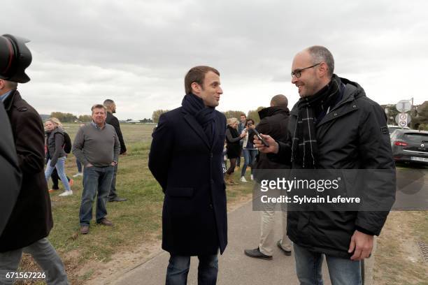Candidate for the 2017 presidential election, Emmanuel Macron and head of the political movement En Marche! discusses with a local journalist on...