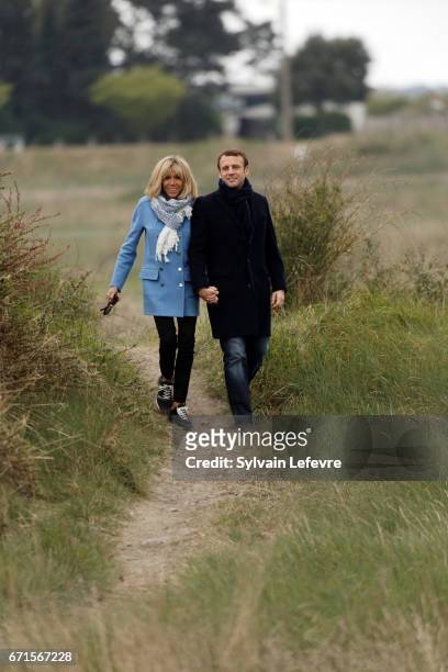 Candidate for the 2017 presidential election, Emmanuel Macron and head of the political movement En Marche! and his wife Brigitte Trogneux pose for...