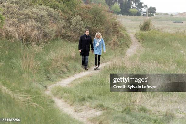 Candidate for the 2017 presidential election, Emmanuel Macron and head of the political movement En Marche! and his wife Brigitte Trogneux pose for...