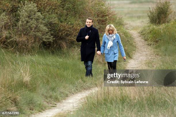 Candidate for the 2017 presidential election, Emmanuel Macron and head of the political movement En Marche! and his wife Brigitte Trogneux pose for...