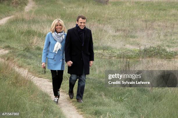 Candidate for the 2017 presidential election, Emmanuel Macron and head of the political movement En Marche! and his wife Brigitte Trogneux pose for...