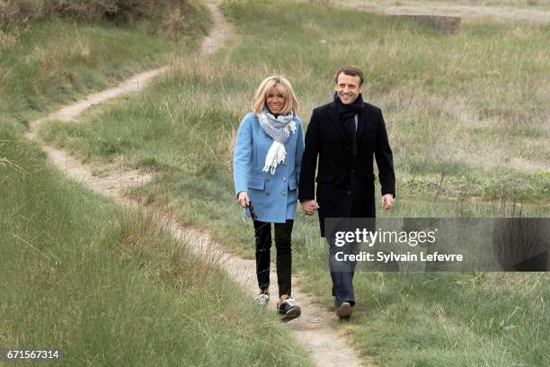 Candidate for the 2017 presidential election, Emmanuel Macron and head of the political movement En Marche! and his wife Brigitte Trogneux pose for...