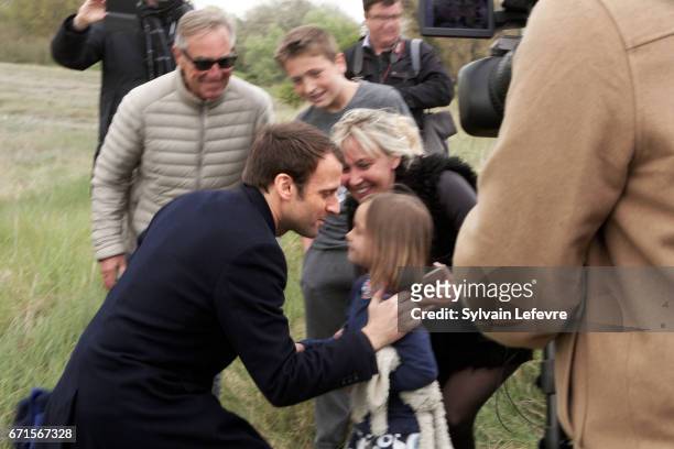 Candidate for the 2017 presidential election, Emmanuel Macron and head of the political movement En Marche! greets his supporters on April 22, 2017...