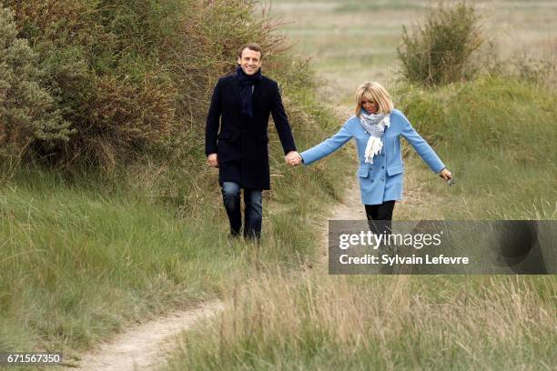 Candidate for the 2017 presidential election, Emmanuel Macron and head of the political movement En Marche! and his wife Brigitte Trogneux pose for...