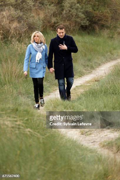 Candidate for the 2017 presidential election, Emmanuel Macron and head of the political movement En Marche! and his wife Brigitte Trogneux pose for...