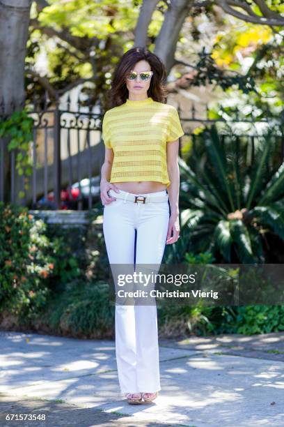 Model Julia Lescova wearing white jeans Rag&Bone, French Mauve yellow striped top, Chloe shoes, Celine sunglasses, Chanel bag on April 21, 2017 in...