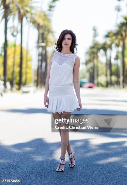 Model Julia Lescova wearing a white dress Magali Pascal, shoes Gianvito Rossi on April 21, 2017 in Los Angeles, California.