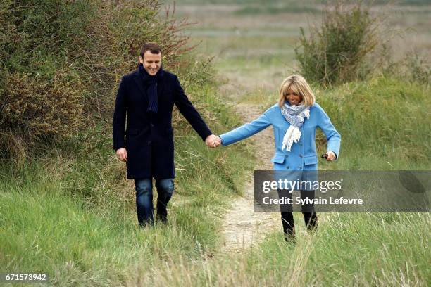 Candidate for the 2017 presidential election, Emmanuel Macron and head of the political movement En Marche! and his wife Brigitte Trogneux pose for a...