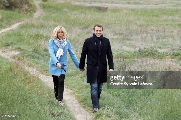 Candidate for the 2017 presidential election, Emmanuel Macron and head of the political movement En Marche! and his wife Brigitte Trogneux pose for a...