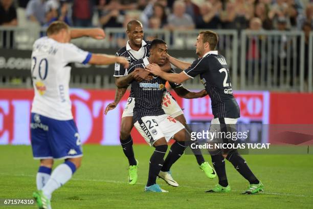 Bordeaux's Brazilian forward Malcom celebrates with teammates after scoring a goal during the French Ligue 1 football match between Bordeaux and...