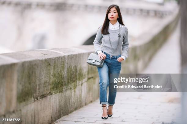 May Berthelot, Head of Legal at Videdressing.com and fashion blogger, wears a Chanel white shirt, a Balzac gray knit sweater, The Kooples jeans,...