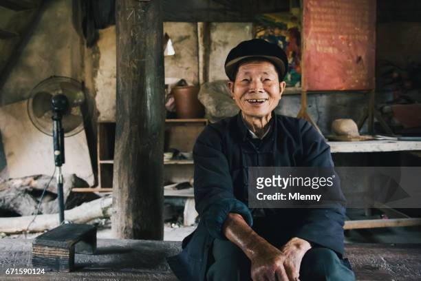 smiling chinese senior man chengyang china real people portrait - tribal head gear in china stock pictures, royalty-free photos & images