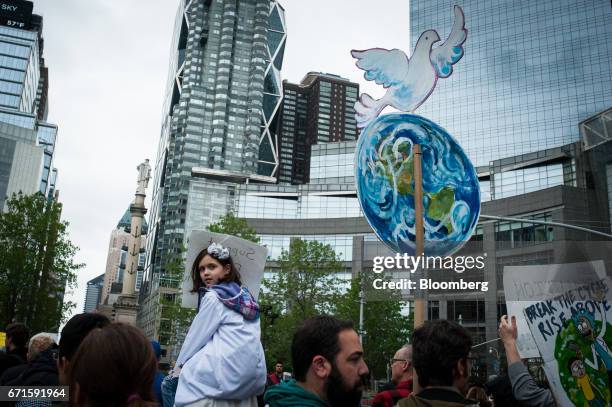 Demonstrators carry signs outside of the Trump International Hotel and Tower during the March for Science rally on Earth Day in New York, U.S., on...