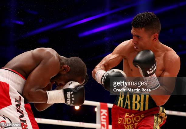 Mohammed Rabii of Morocco and Jean Pierre Habimana of Belgium exchange punches during their super welterweight fight at Messehalle Erfurt on April...
