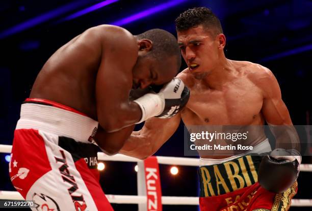 Mohammed Rabii of Morocco and Jean Pierre Habimana of Belgium exchange punches during their super welterweight fight at Messehalle Erfurt on April...