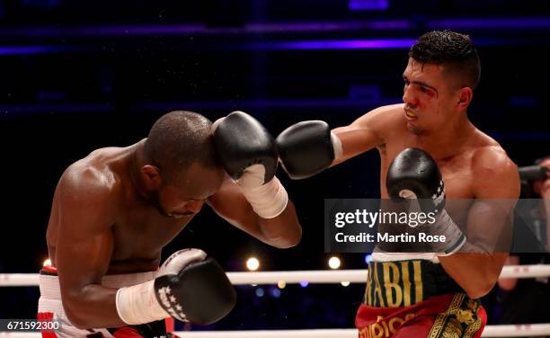 Mohammed Rabii of Morocco and Jean Pierre Habimana of Belgium exchange punches during their super welterweight fight at Messehalle Erfurt on April...