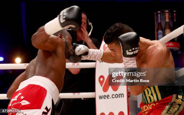 Mohammed Rabii of Morocco and Jean Pierre Habimana of Belgium exchange punches during their super welterweight fight at Messehalle Erfurt on April...