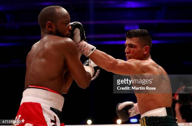 Mohammed Rabii of Morocco and Jean Pierre Habimana of Belgium exchange punches during their super welterweight fight at Messehalle Erfurt on April...
